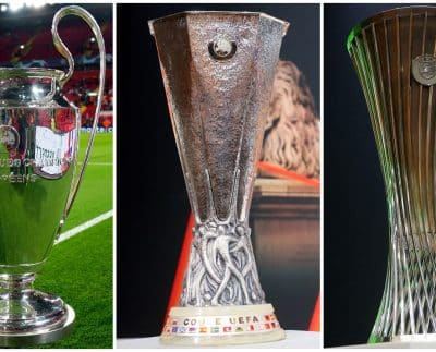 Champions League trophy next to the Europa League and Europa Conference League trophies.